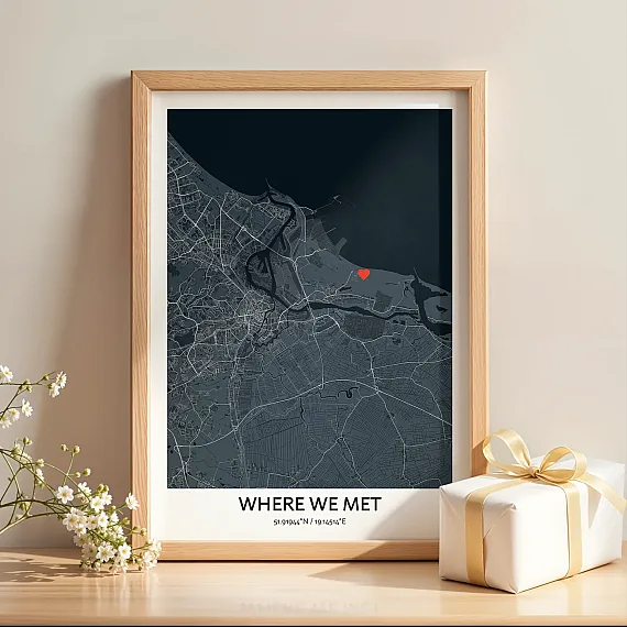 Framed “Where We Met” map poster with a red heart location marker displayed next to a gift box.