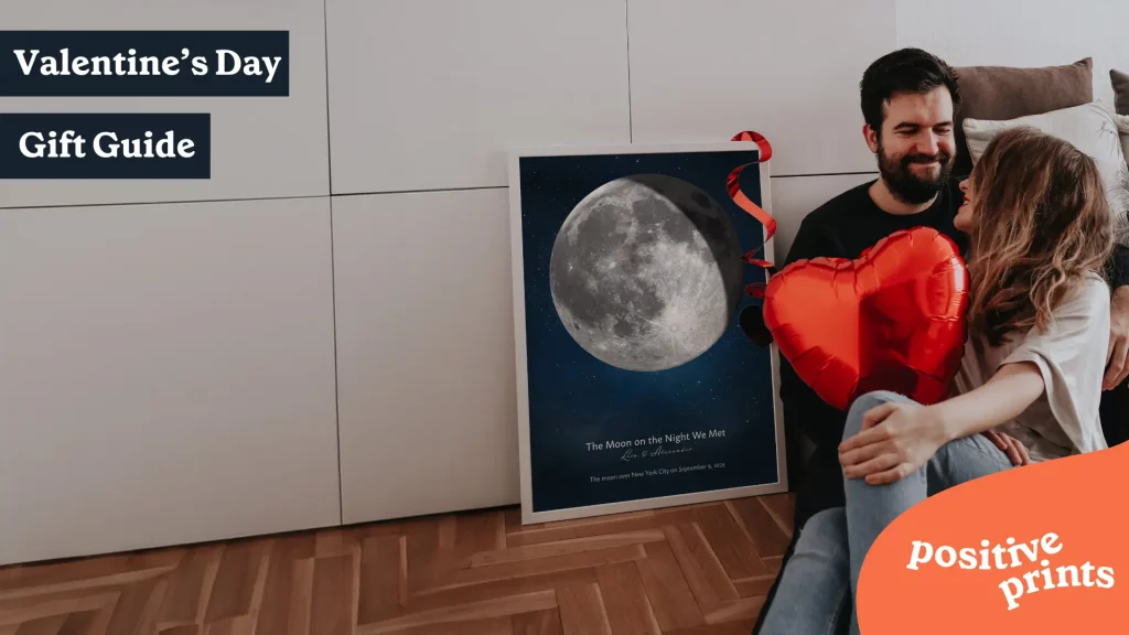 Couple celebrating Valentine’s Day with personalized moon phase print and heart balloon from Positive Prints